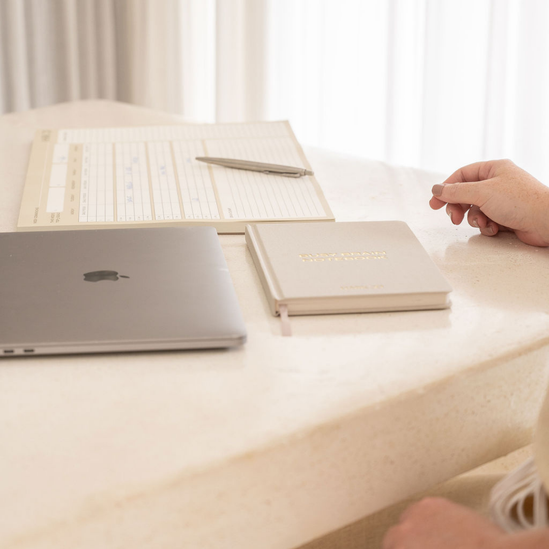 Hark Busy Brain Notebook and Desk Planner beside a laptop, creating a simple planning system for busy minds