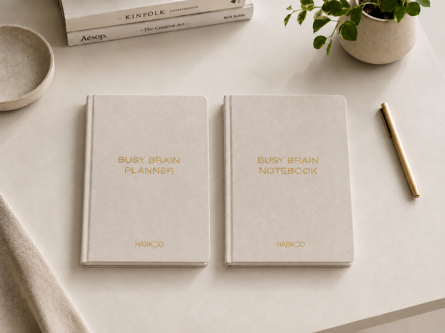 Hark Busy Brain Notebook and undated Busy Brain Planner styled together on a desk